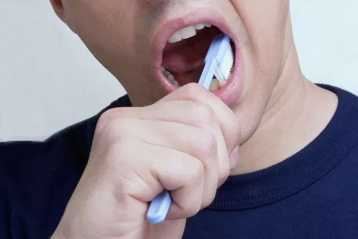 Man brushing teeth